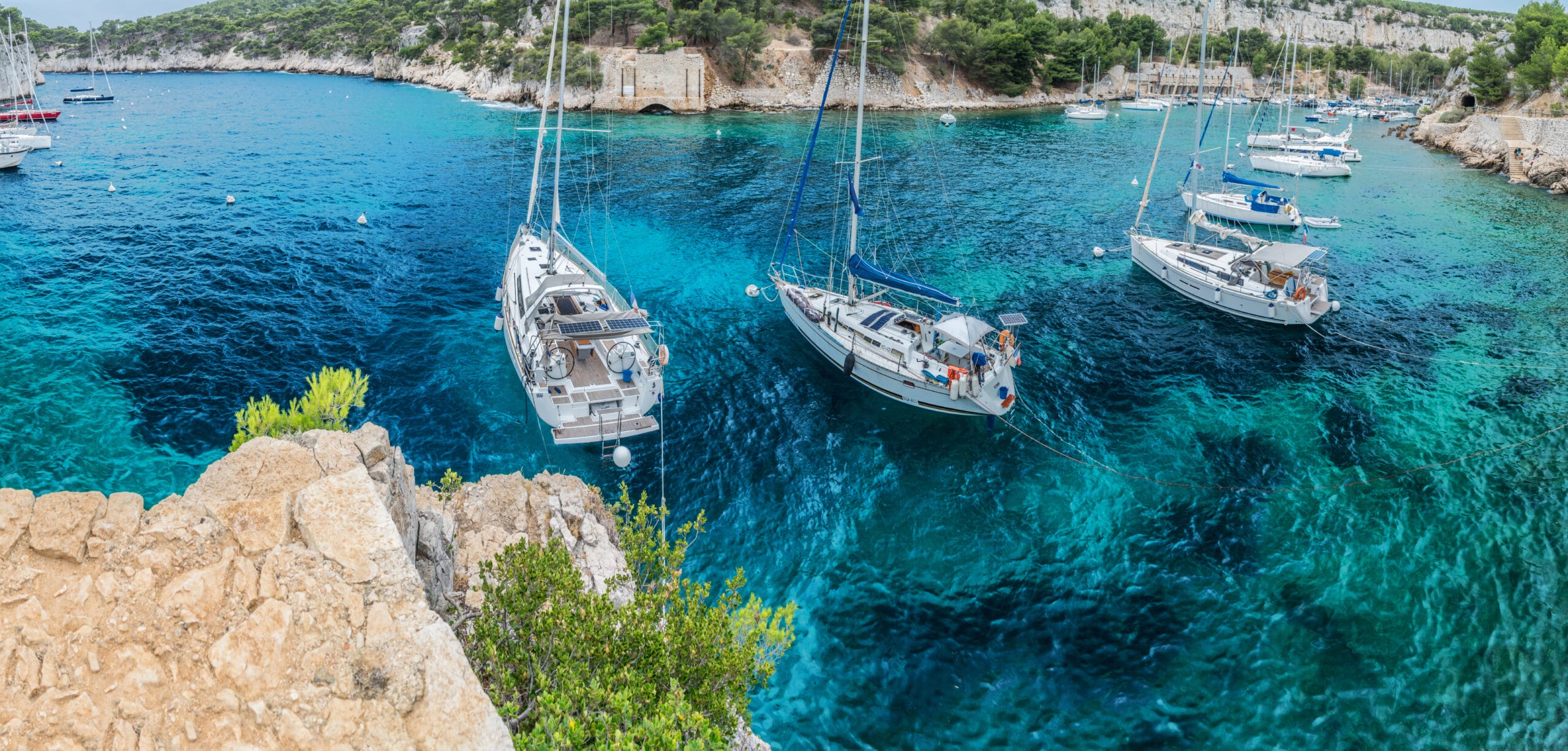 Boats anchored in a sheltered coastal cove
